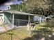 Fenced backyard with patio and shade, along with storage shed at 2001 E Powhatan Ave, Tampa, FL 33610