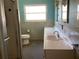 This bathroom features a pedestal sink and a walk in shower at 2001 E Powhatan Ave, Tampa, FL 33610