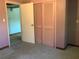 Bedroom with pink walls and closet with louvered doors at 2001 E Powhatan Ave, Tampa, FL 33610