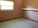 Bedroom featuring neutral carpeting and a window overlooking the yard at 2001 E Powhatan Ave, Tampa, FL 33610