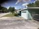 Charming home with a well-manicured lawn, a driveway, and an attached garage at 2001 E Powhatan Ave, Tampa, FL 33610