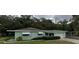 Inviting single-story home with a covered entrance, attached garage, and manicured shrubbery at 2001 E Powhatan Ave, Tampa, FL 33610