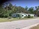 Charming single-story home with a well-maintained lawn and mature trees in a desirable neighborhood at 2001 E Powhatan Ave, Tampa, FL 33610