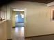 The hallway with tile flooring leads to rooms with painted walls and visible windows at 2001 E Powhatan Ave, Tampa, FL 33610