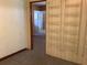 Hallway leading to another room with wire shelves on one wall at 2001 E Powhatan Ave, Tampa, FL 33610