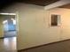 The interior hallway features painted walls, tile flooring, and an open doorway to adjacent rooms at 2001 E Powhatan Ave, Tampa, FL 33610