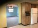 View from kitchen into carpeted Living Room at 2001 E Powhatan Ave, Tampa, FL 33610