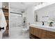 Stylish bathroom featuring marble tile, updated fixtures, and a wooden vanity at 207 S Coolidge Ave, Tampa, FL 33609