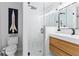 Modern bathroom featuring a glass-enclosed shower, wood vanity, and updated fixtures at 207 S Coolidge Ave, Tampa, FL 33609