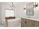 Modern bathroom featuring a soaking tub and updated vanity with sleek fixtures at 207 S Coolidge Ave, Tampa, FL 33609