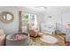 Bedroom featuring a crib, chair, accent rug, and plentiful natural light at 207 S Coolidge Ave, Tampa, FL 33609