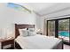 Bedroom with access to the pool area, featuring neutral colors and natural light at 207 S Coolidge Ave, Tampa, FL 33609