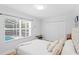 Bedroom with a window overlooking the pool, featuring a closet and simple decor at 207 S Coolidge Ave, Tampa, FL 33609