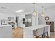 Bright, modern kitchen with white cabinetry, stone countertops, stainless steel appliances, and wood flooring at 207 S Coolidge Ave, Tampa, FL 33609