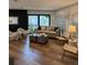 Bright living room with hardwood floors, fireplace, and view to the outdoor space at 207 S Coolidge Ave, Tampa, FL 33609