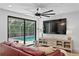 Cozy living room with a view of the pool, a large TV, and comfortable seating at 207 S Coolidge Ave, Tampa, FL 33609