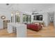 Open-concept living room with hardwood floors, a pool view, and a stylish leather sofa at 207 S Coolidge Ave, Tampa, FL 33609