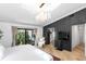 Bright main bedroom featuring a chandelier, sliding glass doors, and accent wall at 207 S Coolidge Ave, Tampa, FL 33609