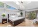 Bright main bedroom with hardwood flooring, a chandelier, and sliding glass doors at 207 S Coolidge Ave, Tampa, FL 33609