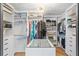 Walk-in closet with custom shelving, center island, and a decorative light fixture at 207 S Coolidge Ave, Tampa, FL 33609
