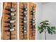 Close up of custom wine rack with wood accents and ambient lighting, with bottle details at 207 S Coolidge Ave, Tampa, FL 33609