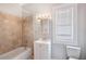 Bathroom featuring a tub with tiled surround, vanity, and window at 2317 W Chestnut St, Tampa, FL 33607