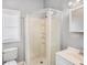 Bathroom featuring a shower, toilet, vanity, and window with blinds at 2317 W Chestnut St, Tampa, FL 33607