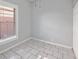 Simple bedroom with tile flooring, closet space, and a bright window at 2317 W Chestnut St, Tampa, FL 33607