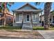 Charming single-story home featuring a quaint front porch and manicured landscaping at 2317 W Chestnut St, Tampa, FL 33607