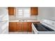 Kitchen showcasing wood cabinets, a dual-basin sink, and a white stove and refrigerator at 2317 W Chestnut St, Tampa, FL 33607