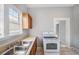 Kitchen showing a double sink, wood cabinets, and a white stove at 2317 W Chestnut St, Tampa, FL 33607