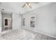 Living room showcasing tile flooring, a ceiling fan, and an open doorway at 2317 W Chestnut St, Tampa, FL 33607
