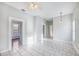 Spacious living area showcasing tile flooring, ceiling fan, and access to other rooms at 2317 W Chestnut St, Tampa, FL 33607