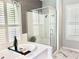 Relaxing bathroom with a soaking tub, glass-enclosed shower, and plenty of natural light at 2332 Dekan Ln, Land O Lakes, FL 34639