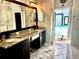 Bathroom boasts a large vanity, marble tile, and access to a pool for convenience and luxury at 2332 Dekan Ln, Land O Lakes, FL 34639