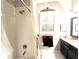 Clean bathroom with a shower, black vanity, and black and red themed accessories at 2332 Dekan Ln, Land O Lakes, FL 34639