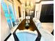 Refined dining room with a chandelier, elegant seating, and shuttered windows at 2332 Dekan Ln, Land O Lakes, FL 34639