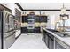 Gourmet kitchen boasts stainless steel appliances, marble floors, and a stylish wine rack at 2332 Dekan Ln, Land O Lakes, FL 34639