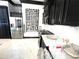 Chic kitchen showcases marble countertops, stainless steel appliances, and a modern wine rack at 2332 Dekan Ln, Land O Lakes, FL 34639