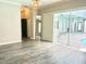 Living area featuring sliding glass doors, wood floors, and neutral paint offer a modern and bright space at 2332 Dekan Ln, Land O Lakes, FL 34639