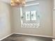 Cozy living room area with hardwood floors, a window seat and a decorative hanging light fixture at 2332 Dekan Ln, Land O Lakes, FL 34639
