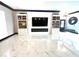 Bright living room with marble floors, modern built-ins, and a cozy fireplace at 2332 Dekan Ln, Land O Lakes, FL 34639