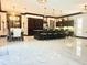 Expansive living area with a kitchen island, dining table, and modern lighting at 2332 Dekan Ln, Land O Lakes, FL 34639