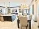 Open-concept living space featuring a kitchen island, dining area, and a cozy seating area at 2332 Dekan Ln, Land O Lakes, FL 34639