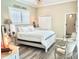 Bright main bedroom with a neutral palette, shuttered windows, and stylish furniture at 2332 Dekan Ln, Land O Lakes, FL 34639
