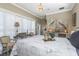Well-decorated main bedroom with natural light, shuttered windows, a chandelier, and a comfortable bed at 2332 Dekan Ln, Land O Lakes, FL 34639