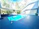 Features an enclosed pool area with lounge seating, a bar, and a screened-in patio for outdoor enjoyment at 2332 Dekan Ln, Land O Lakes, FL 34639