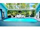Inviting screened-in pool area perfect for relaxation and entertaining with a wet bar and outdoor seating at 2332 Dekan Ln, Land O Lakes, FL 34639