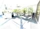 Bright sun room featuring hanging chairs, a kitchen area, and glass windows overlooking the scenic outdoors at 2332 Dekan Ln, Land O Lakes, FL 34639