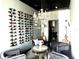 Features a wine room with a modern wine rack, chandelier, seating and decor creating an elegant space at 2332 Dekan Ln, Land O Lakes, FL 34639